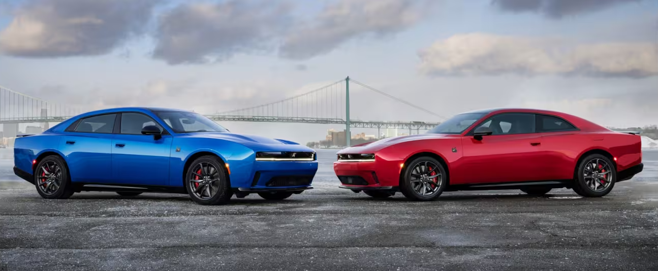 Two 2026 Dodge Chargers parked by bridge