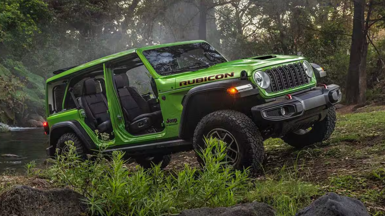 Green 2026 Jeep Wrangler Rubicon driving off-road