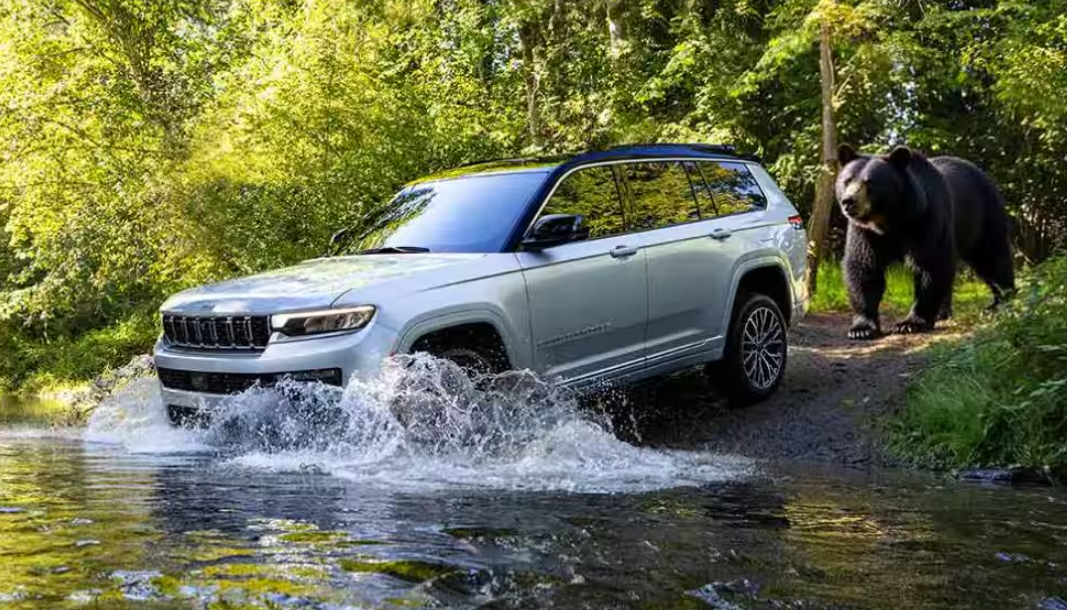 Silver 2026 Jeep Grand Cherokee driving through water