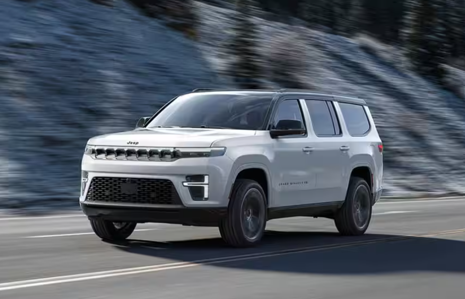 White 2026 Jeep Grand Wagoneer driving on road