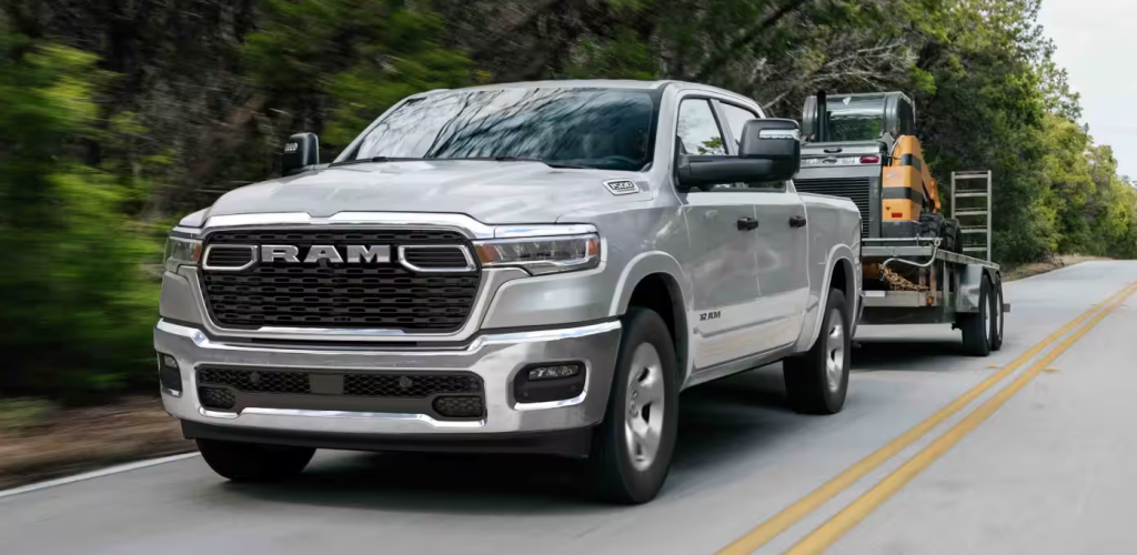 Silver 2026 Ram 1500 towing a trailer