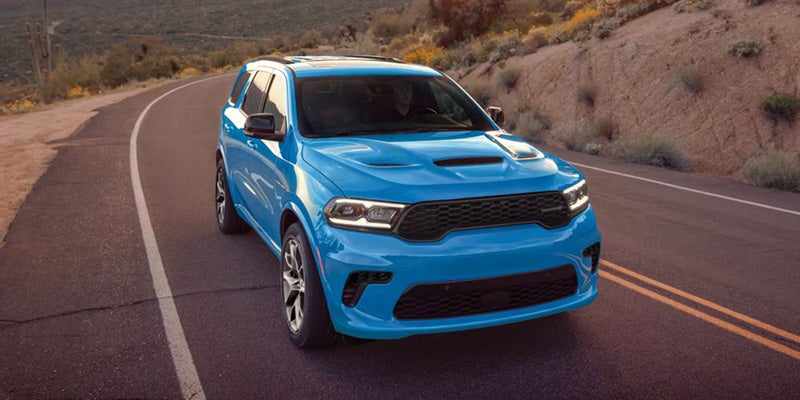 Blue 2027 Dodge Durango driving on the road