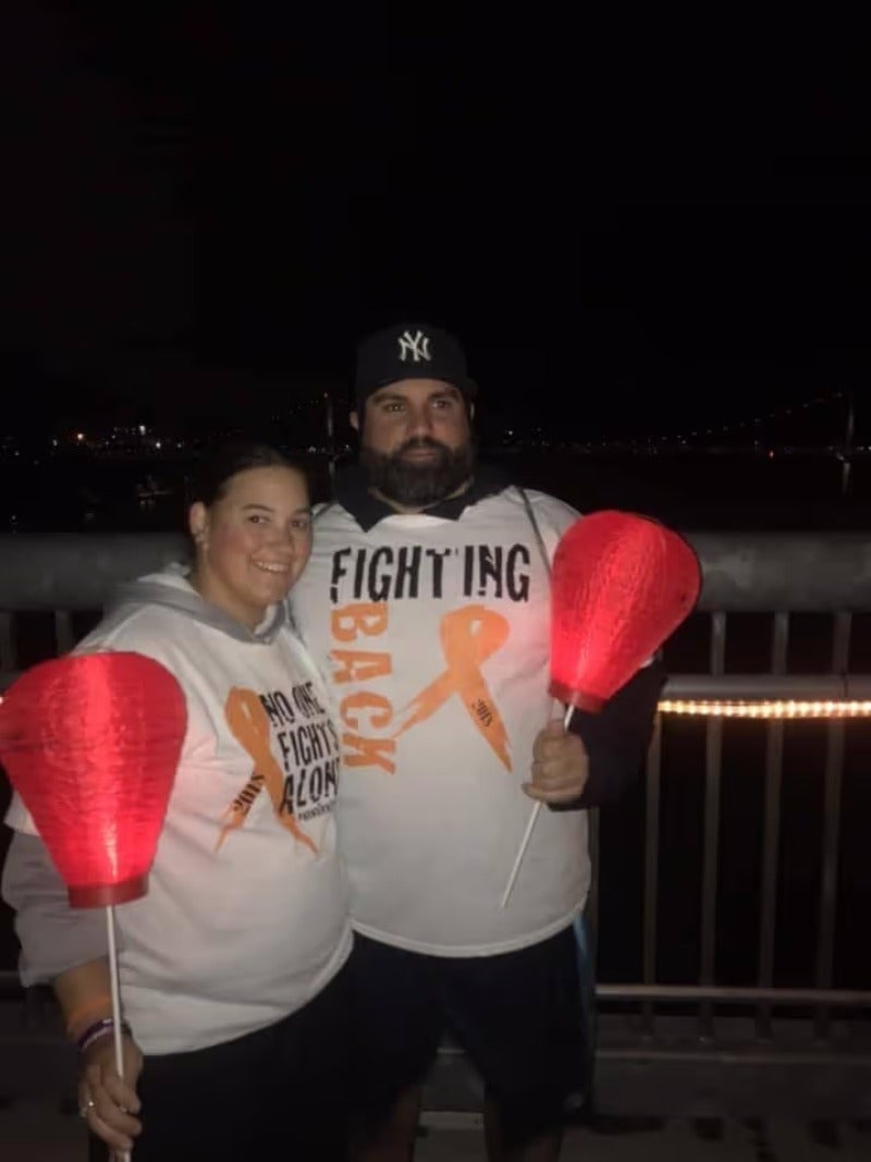 A man and a woman standing with lamp in hand.